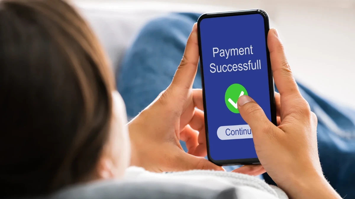 Online mobile money payment successful on a cell phone, illustrating online payment gateways for businesses.