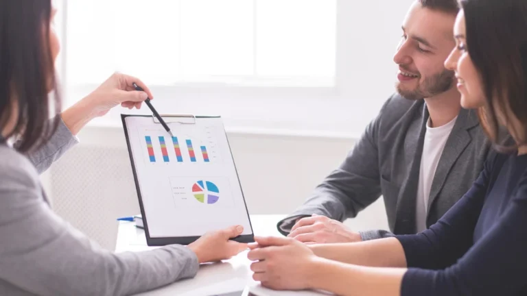 Financial advisor discussing financial planning and budgeting tips with a couple.
