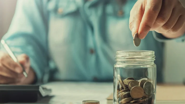 Close-up of a businesswoman saving money, illustrating finance and accounting concepts in an office setting.