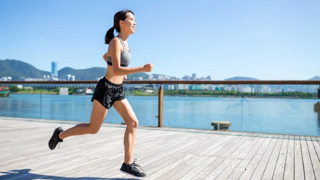Young woman jogging on the boardwalk